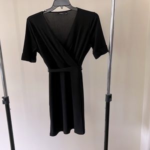 Women’s black M short sleeve V neck dress.  Like new condition.